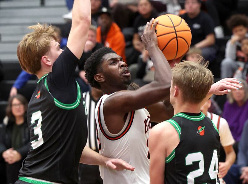 DeKalb's Myles Newman goes up between two Rock Falls defenders during their game Tuesday, Dec. 2, 2025, at DeKalb High School.
