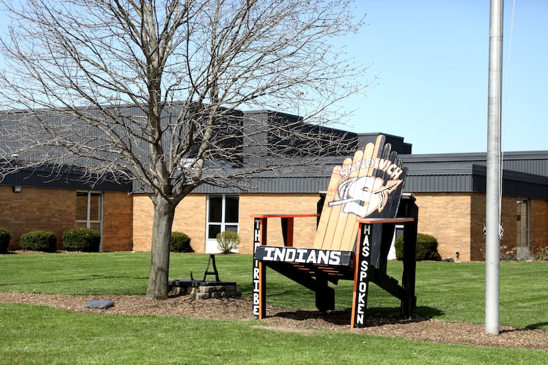 An oversized chair sits outside Sandwich High School.