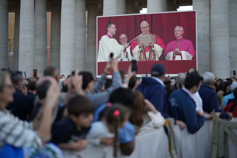Faithful listen the speech of the newly elected Pope Leo XIV at the Vatican, Thursday, May 8, 2025. (AP Photo/Francisco Seco)