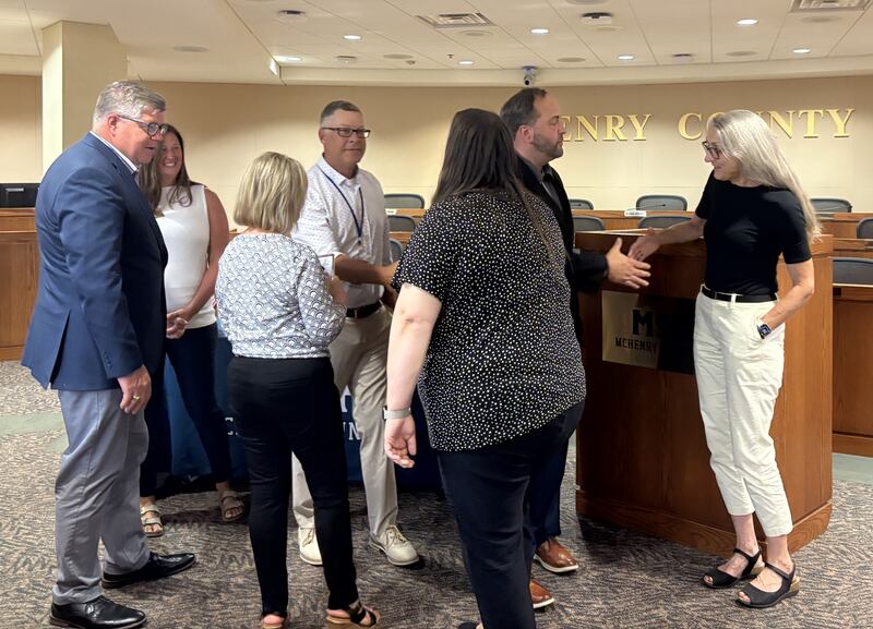 Home of the Sparrow officials and county board members shake hands after the nonprofit won the McHenry County Community Development Partner of the Year June 23, 2025.