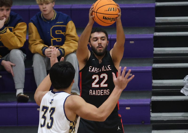 Earlville's Jonathan Anderson looks to pass the ball over the top of Marquette's Slayden Cassel during the Huskers Hardwood Tip-Off Tournament on Tuesday, Nov. 25, 2025 in Serena.