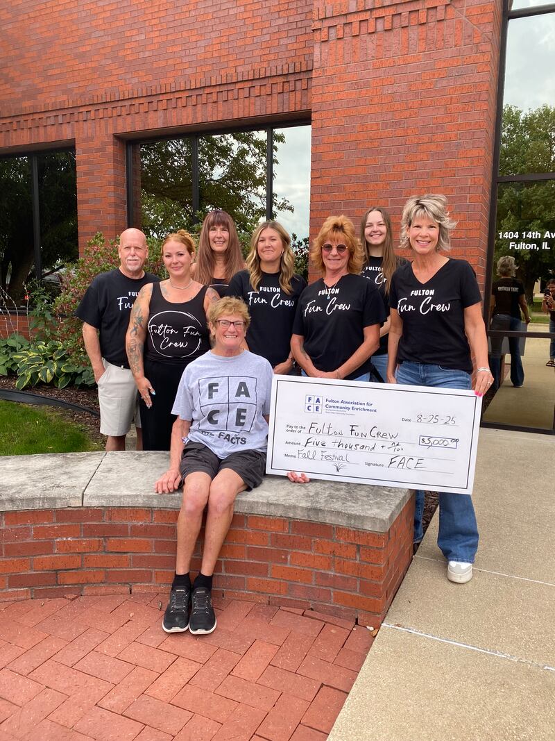 FACE Board member Jean Roeder presents a check $5,000 to the Fulton Fun Crew in support of the various events they sponsor throughout the year.