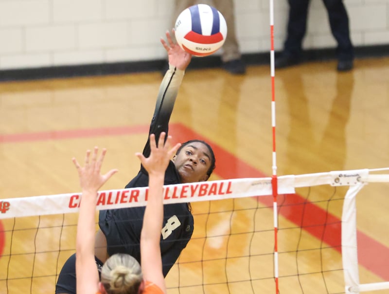 Sycamore's Khiara Thomas sends a spike past Washington during the Class 3A Sectional semifinal game on Tuesday, Nov. 4, 2025 in Sellett Gymnasium at L-P High School.