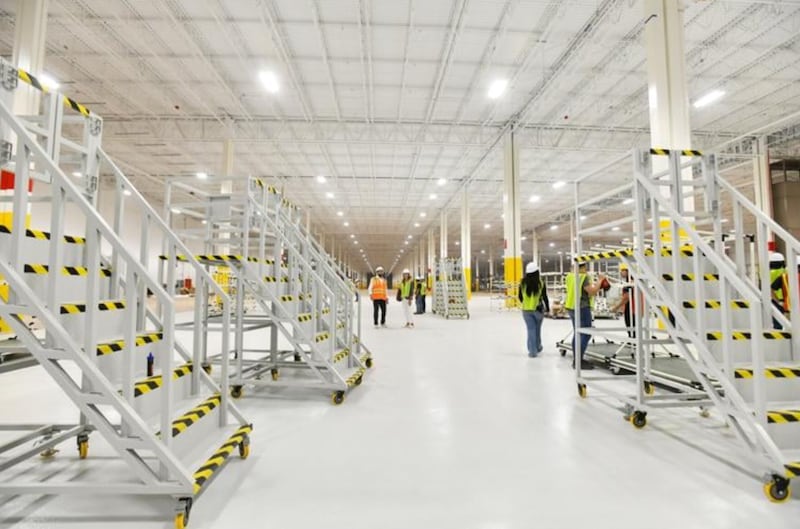 Gotion workers prepare an assembly line in October for filling temperature-controlled battery storage containers with batteries at the Manteno site.
