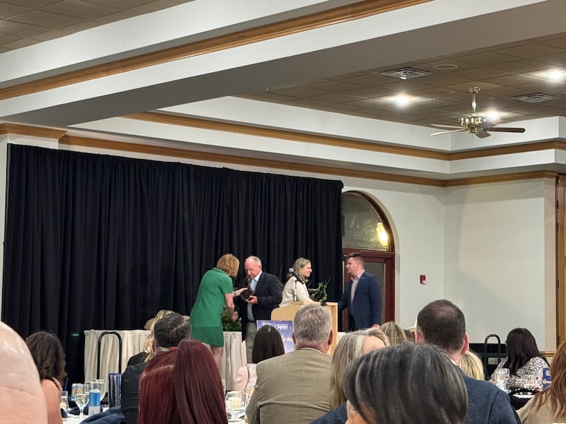 Greg Lyons and Austin Jashari accept the Business of the Year award from Nancy Norton, the President and CEO of the Grundy Economic Development Council on Wednesday, March 5, 2026.