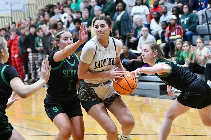 Bishop McNamara's Trinity Davis maneuvers through Seneca defenders during the Fightin' Irish's 51-30 victory over Seneca in the IHSA Class 2A Herscher Sectional semifinal on Tuesday, Feb. 25.