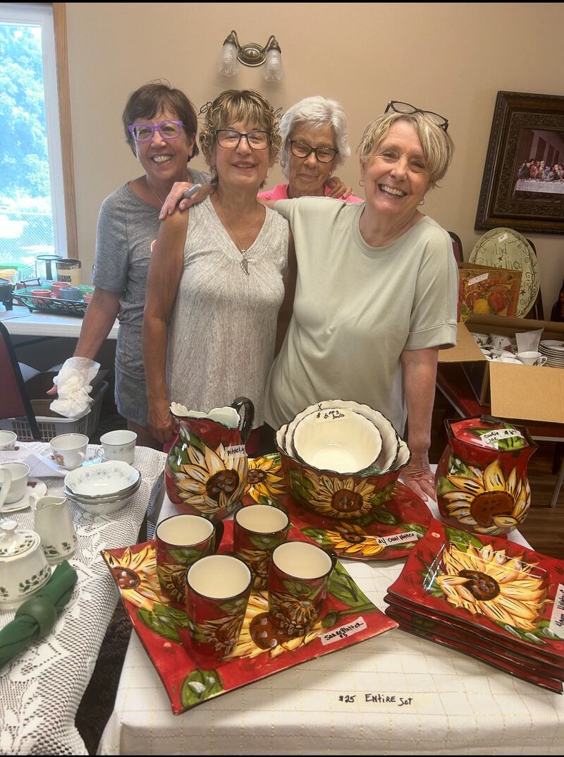 Mary Troglio, Diane Cimei, Sheila Haage and Chris Fiedler prepare for the Granville UCC Rummage sale.
