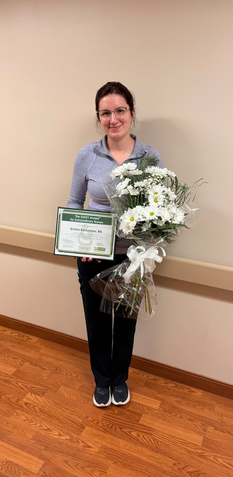 Ermira Ramadani, RN, an intensive care unit nurse at OSF HealthCare Saint Katharine Medical Center in Dixon holds her DAISY Award, earned for providing extraordinary compassionate care for a patient and his family.