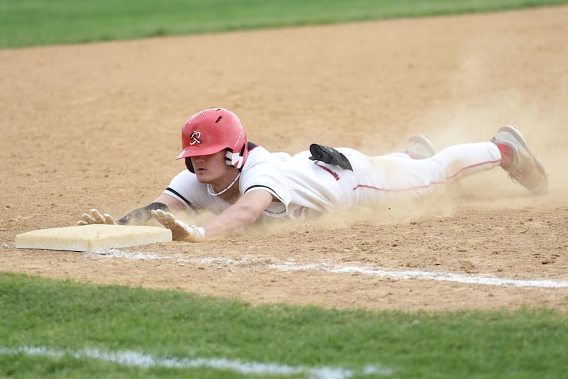 Bradley-Bourbonnais' Sam Frey dives into third base after hitting a triple during a home game against Lincoln-Way East Friday, April 18, 2025.