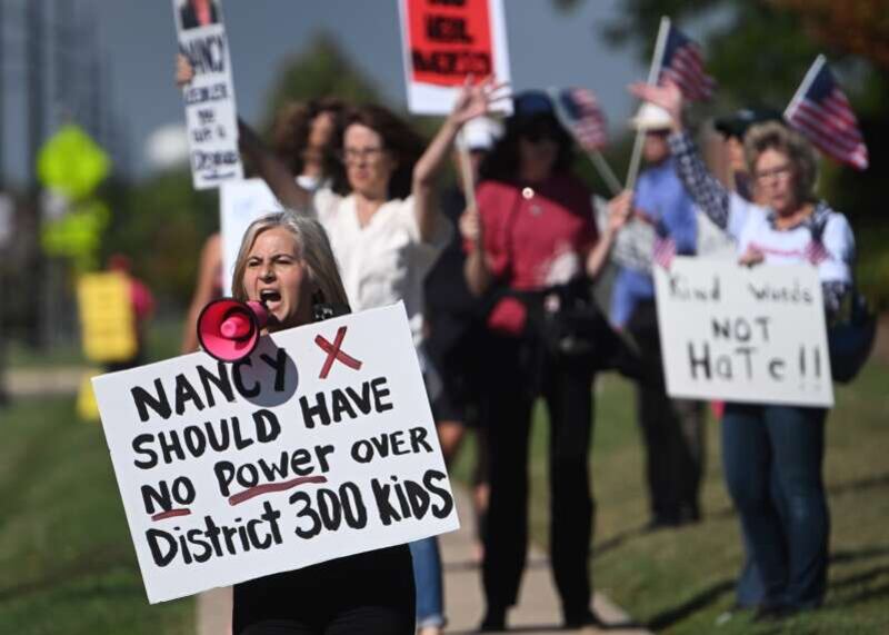 Parent Linda Prestia, left, of Carpentersville, joined about 60 others Monday, Sept. 15, 2025, at District 300 headquarters in Algonquin, demanding that school board president Nancy Zettler step down following a social media post related to the shooting death of activist Charlie Kirk.