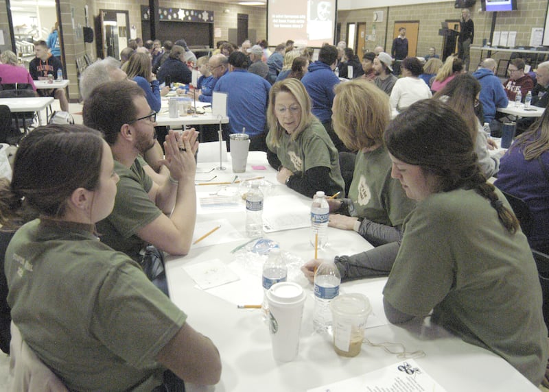 Team "Let's Be Frank" discusses answers at the Stupor Bowl on Saturday, Feb. 8, at Reagan Middle School in Dixon.