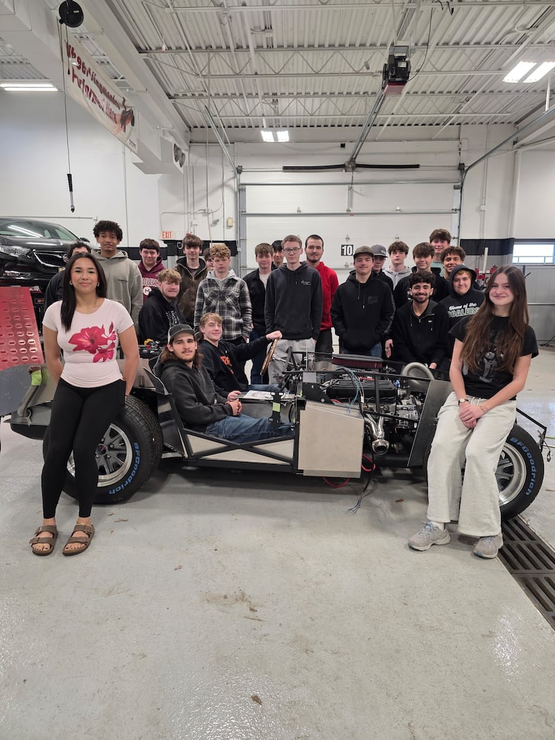 The Grundy Area Vocational Center automotive students with the Shelby Cobra kit car, which they hope to get started for the first time after spring break.