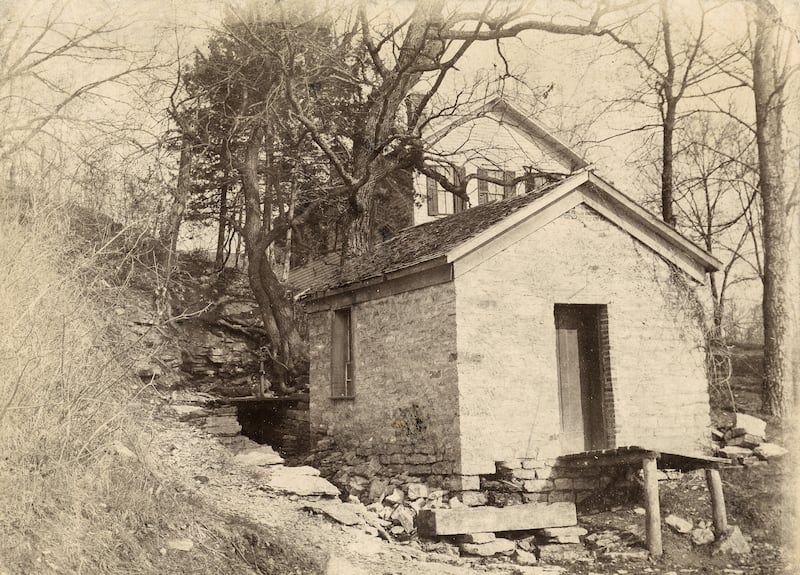 The Fuller home (rear) and spring house faced the river along today’s White Oak Lane. The cave was to the left of these buildings.