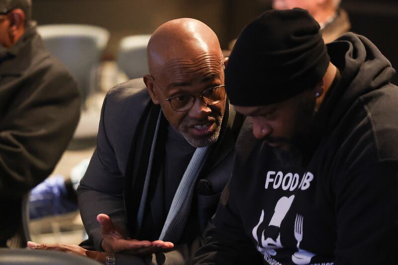 Larry Crawford, left, talks with Marcel L. Richardson at a special Joliet Electoral Board meeting at Joliet City Hall on Tuesday, Dec. 3, 2024 in Joliet.