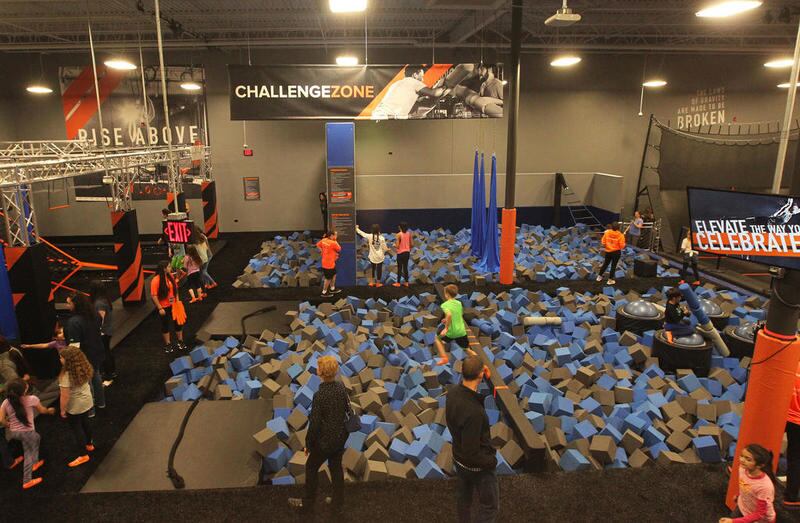 Children have fun in the Challenge Zone foam pit area during the 2018 grand opening of the Sky Zone Vernon Hills indoor trampoline park.