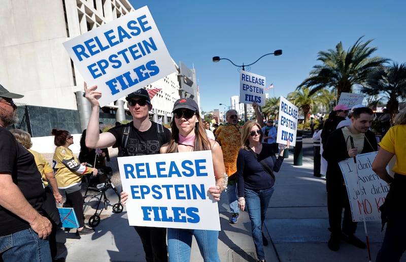 Demonstrators hold signs asking for the release of the Epstein files during a "No Kings" protest in downtown Las Vegas Saturday, Oct. 18, 2025. (Steve Marcus  /Las Vegas Sun via AP)
