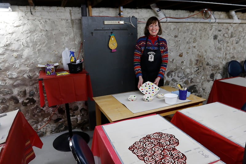 Anne Marie Whitmore Lenzini of the Clayworkers' Guild of Illinois inside the guilds classroom and event space on Fen 5, 2025, in the basement of their Artisans on Main gallery in Woodstock. The guild is expanding their Artisans on Main gallery into a neighboring space behind their Woodstock location. The space, that was formerly the Woodstock Tobacco Hub, will house the guild's classroom space.