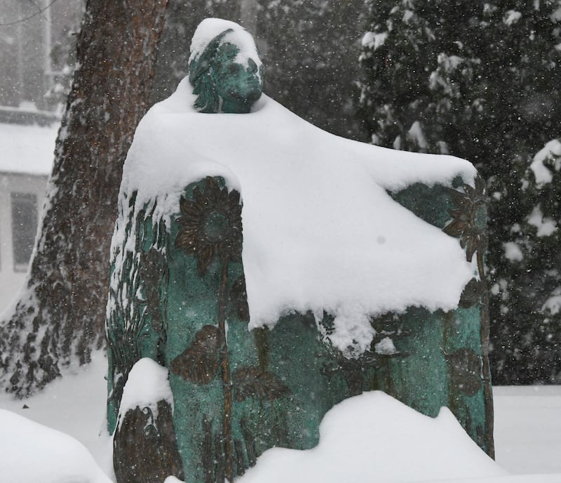 The Bountiful Bench statue was covered with snow on Saturday, Nov. 29, 2025 as several inches fall across the Northern Illinois region. This sculpture, created by Christina Murphy in 2008, graces the lawn of the Oregon Public Library and was inspired by the beauty of the Rock River and woman of nature.