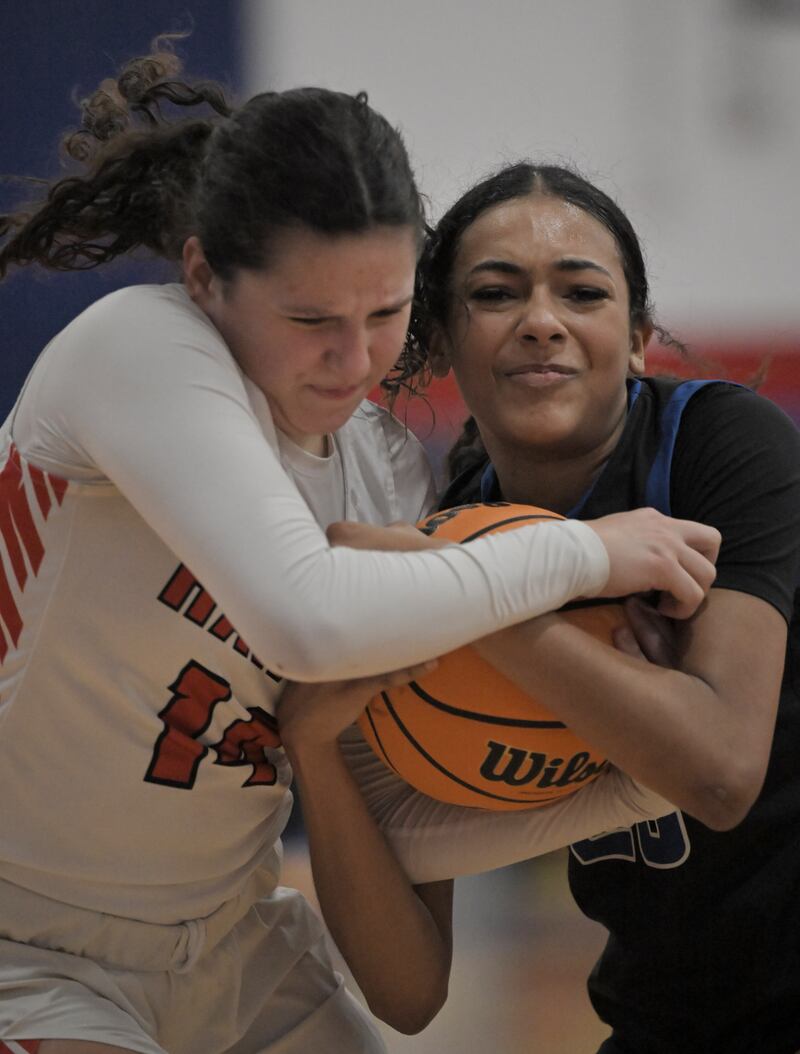 Maine South’s Hayden Fahy and St. Charles North’s Sydney Johnson battle for possession of the ball in a semifinal game of the Dundee-Crown holiday tournament in Carpentersville on Monday, Dec. 29, 2025.