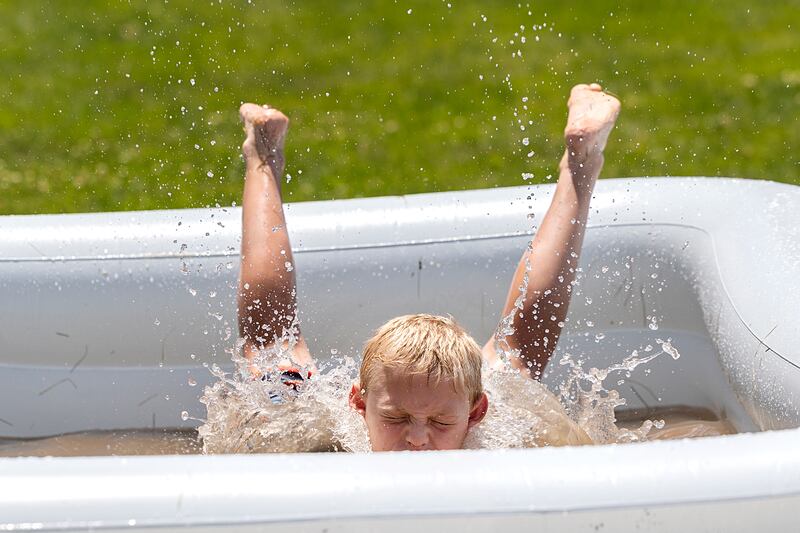 Jackson Wolf, 9, dives into a pool during a spirited game of kick ball Tuesday, June 18, 2024 during Dixon Park District’s SPARK Camp.