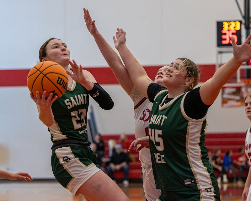 Lili McClain (23) of St. Bede leaps into layup as teammate Savannah Bray (45) Gortat screens Hall's defender on Saturday, January 31, 2026 at Hall High School in Spring Valley.
