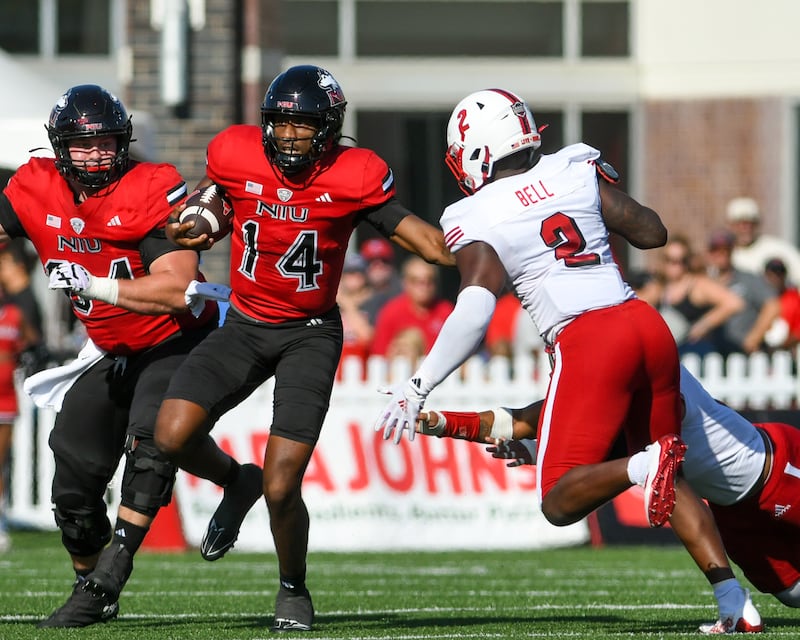 Northern Illinois University's quarterback Jalen Macon (14) runs the ball while gaining some yards before being brought down by Miami of Ohio defenders during the game on Saturday Oct. 4, 2025, held at Huskie Stadium.