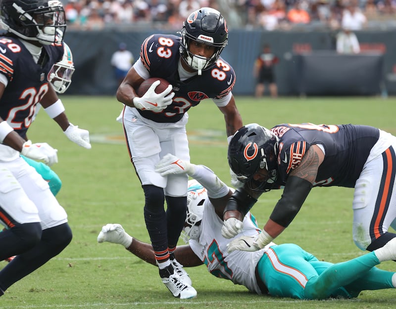 Chicago Bears wide receiver Samori Toure avoids the tackle of Miami Dolphins linebacker Dequan Jackson Sunday, Aug. 10, 2025, during their game at Soldier Field in Chicago.