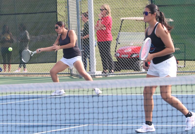 Ottawa number one double tennis players Zulee Moreland and Yaquelin Hernandez-Solis return a serve during the Class 1A girls tennis sectionals on Thursday, Oct. 16, 2025 at Ottawa High School.