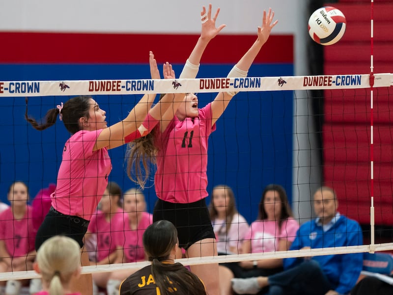 Dundee-Crown's Natalie Olsen, left, and Erin Bruce block a ball at the net during their game against Jacobs on Thursday, October 16, 2025 at Dundee-Crown High School in Carpentersville. Ryan Rayburn for Shaw Local