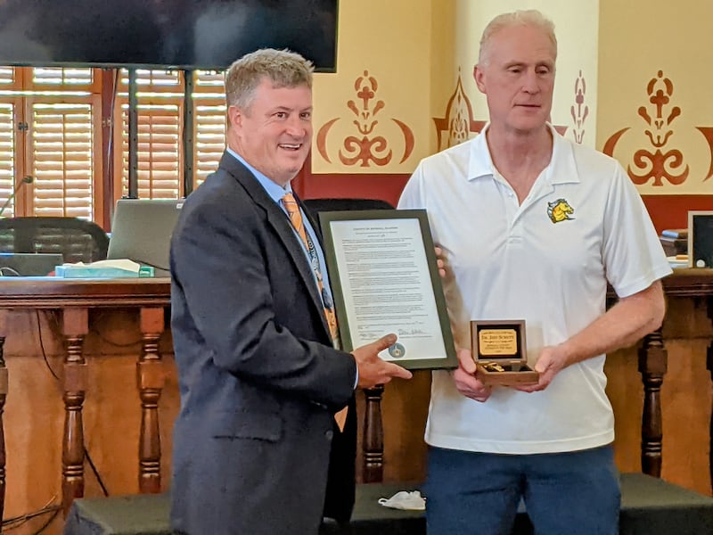 Kendall County Board Chairman Matt Kellogg, left, presents Dr. Jeff Schutt, right, with the Kendall County Citizen of the Year award during the June 17 Kendall County Board meeting.