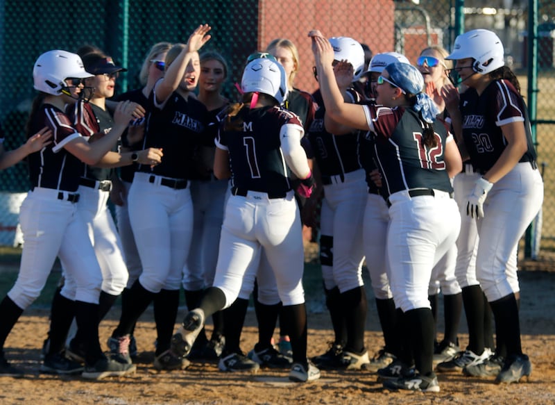 Marengo's Gabby Christopher is greeted by her teammates after hitting a home run during a nonconference softball game against Jacobs on Monday, March 9, 2026, at Marengo High School.