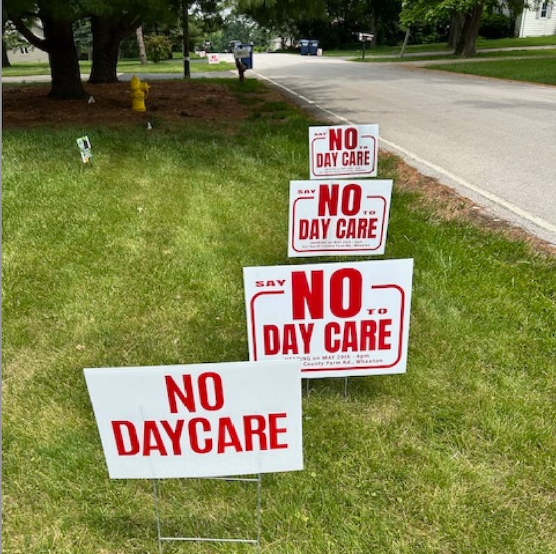 Signs protesting plans for a day care center to be built in an unincorporated area of DuPage County adjacent to Downers Grove line Maple Avenue. Residents say the center would generate too much traffic and poses safety risks