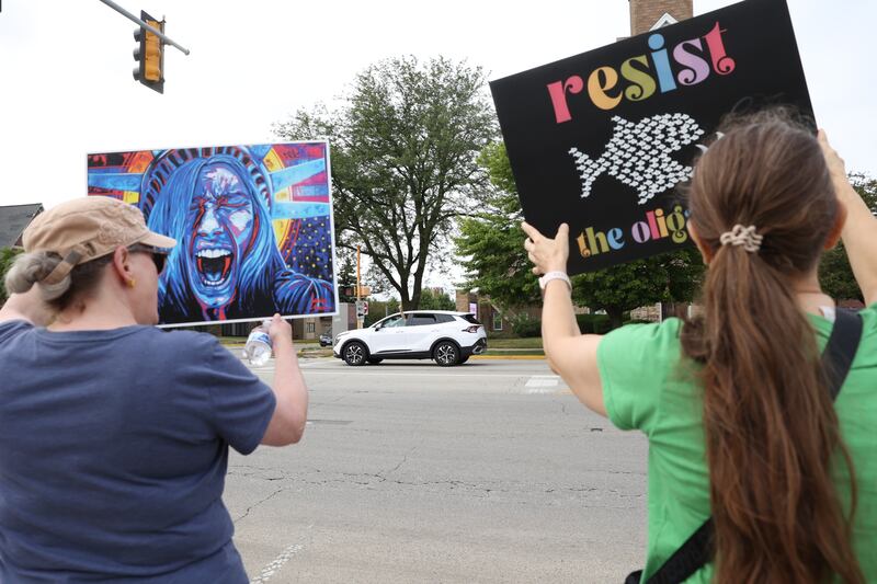 A passing car honks in support past protesters during a "Good Trouble Lives On" rally held in Kankakee as part of a national day of peaceful protests on Thursday, July 17, 2025