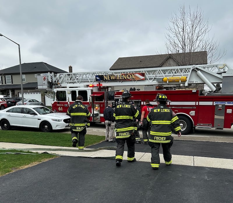 The New Lenox Fire Protection District firefighters at the scene of a residential garage fire in the 800 block of Somerset Court in New Lenox on Friday, April 10, 2026.