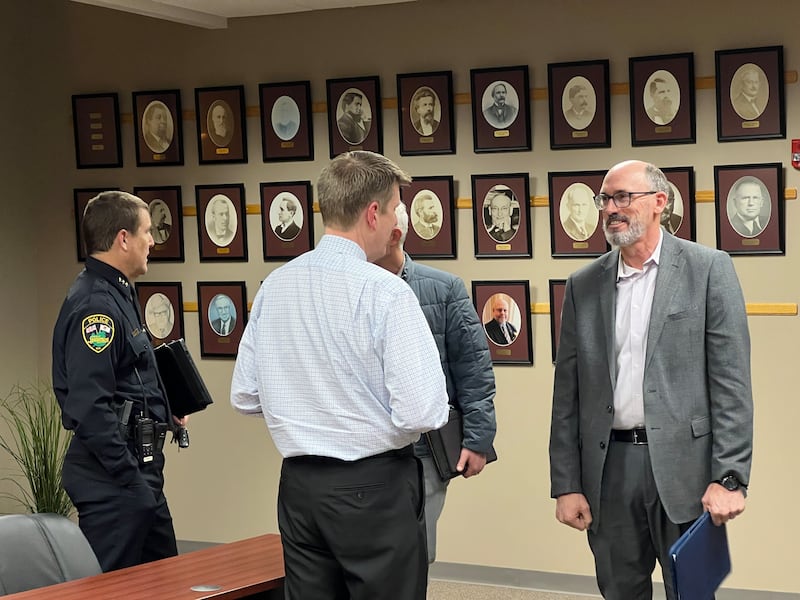 Sycamore Police Chief Jim Winters (left) talks with Public Works Director Matt Anderson while City Manager Michael Hall (middle) speaks with St. Charles Deputy Police Chief Erik Mahan (right) after Sycamore City Council meeting on March 3, 2025. Mahan is expected to be sworn in and replace Winters as Sycamore Police Chief on March 17, 2025.