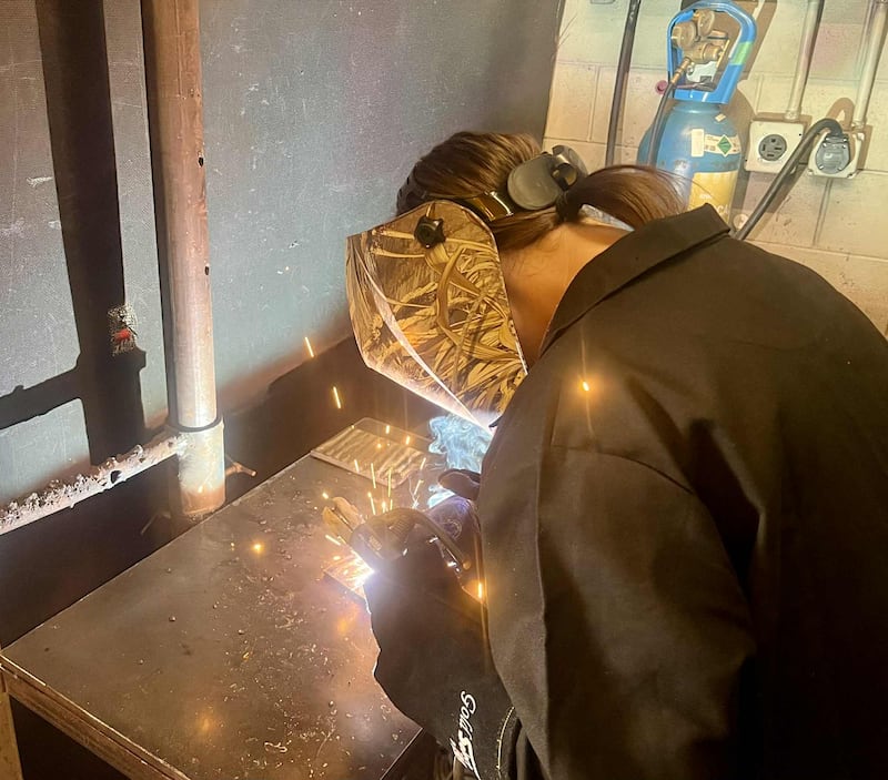 Dixon High School junior Rachel Lance works on a flat weld at the Whiteside Area Career Center's Welding, Machining and Manufacturing program in Sterling.