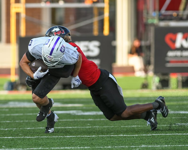 Northern Illinois University's safety Ty Myles, right, tackles Holy Cross’s wide receiver Charly Mullaly during the game on Saturday Aug. 30, 2025, held at Huskie Stadium in DeKalb.