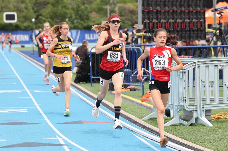 Westmont’s Kyla Babb trails St. Anthony's Isabella Keller in the 3200 m run during the IHSA Class 1A Girls Track & Field State Finals on Saturday, May 24, 2025.