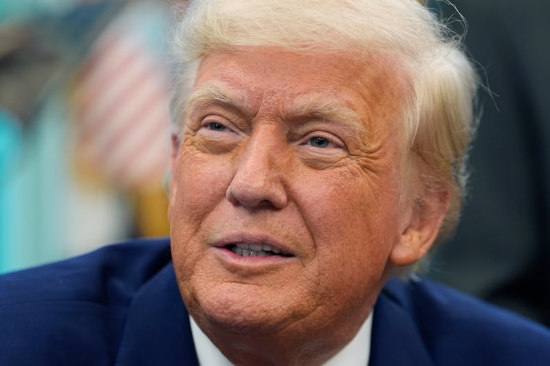 President Donald Trump speaks with reporters as he signs an executive order in the Oval Office of the White House, Friday, May 9, 2025, in Washington. (AP Photo/Alex Brandon)