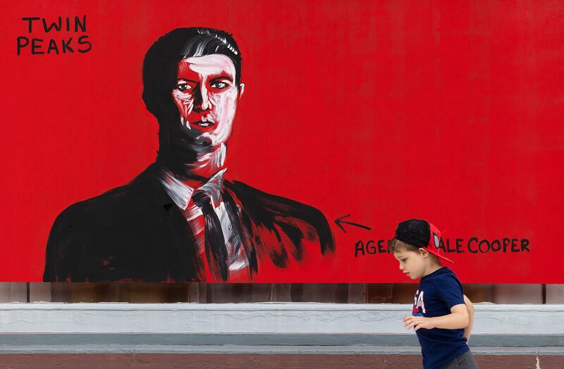 A youngster passes by the Lynchian work of an unknown artist during Morrison’s Paint the Town event Saturday, Sept. 20, 2025.