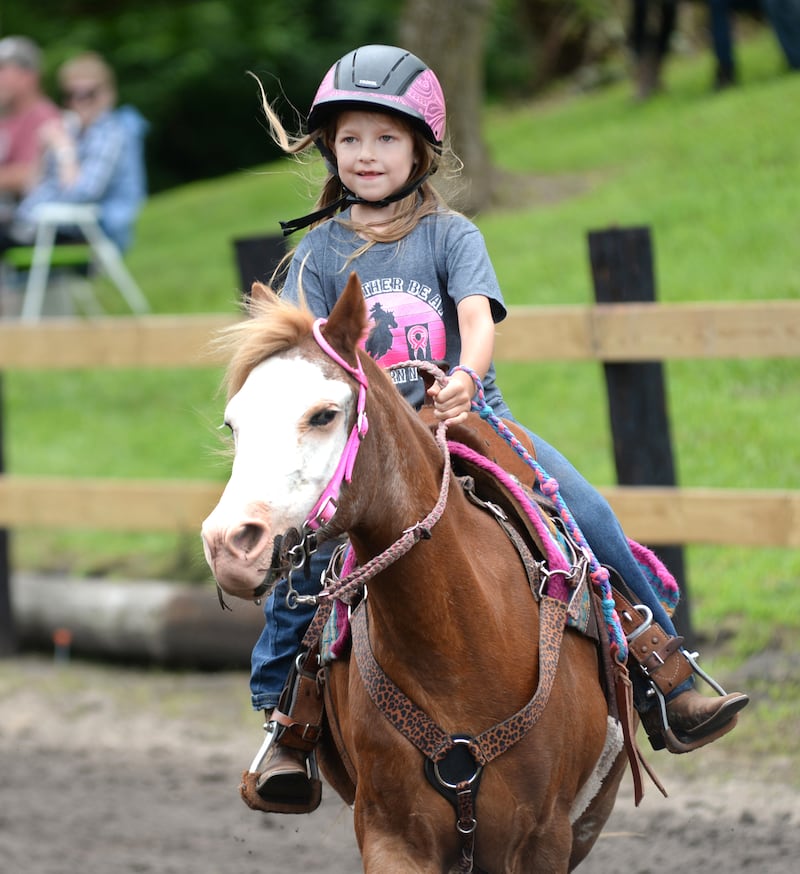 Hadley VanDermyde, 6, of Morrison, smiles as she rides her pony Jubilee in the Flags Competition at the Rock River Trail & Horseman Association's Grand Opening Show on Saturday, July 20, 2024.