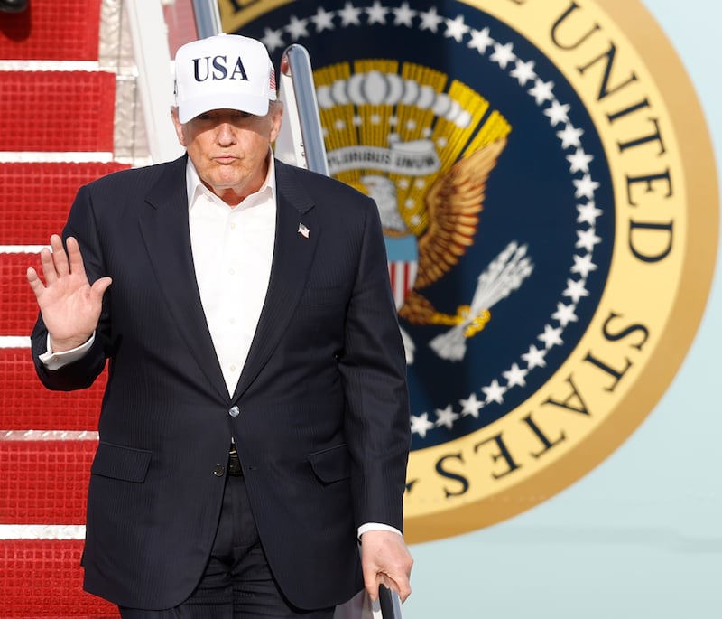 President Donald Trump walks down the stairs of Air Force One upon his arrival at Joint Base Andrews, Md., Friday, May 15, 2026. (AP Photo/Luis M. Alvarez)