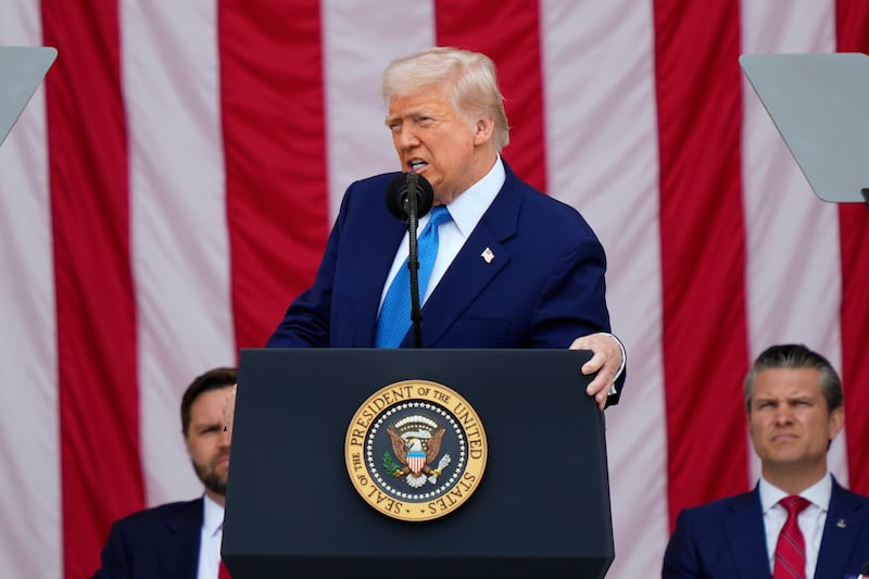 President Donald Trump delivers the Memorial Day Address at the 157th National Memorial Day Observance at Arlington National Cemetery, Monday, May 26, 2025, in Arlington, Va., as Vice President JD Vance and Secretary of Defense Pete Hegseth, right, look on. (AP Photo/Julia Demaree Nikhinson)