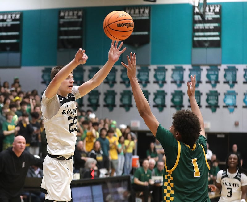 Kaneland's Connor Kimme passes the ball over Crystal Lake South's Noah Cook during the IHSA Class 3A Woodstock North Sectional final basketball game on Friday, March 6, 2026, at Woodstock North High School.