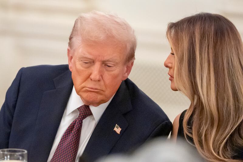 President Donald Trump listens as first lady Melania Trump repeats a question for him during a dinner in the State Dining Room of the White House, Thursday, Sept. 4, 2025, in Washington. (AP Photo/Alex Brandon)