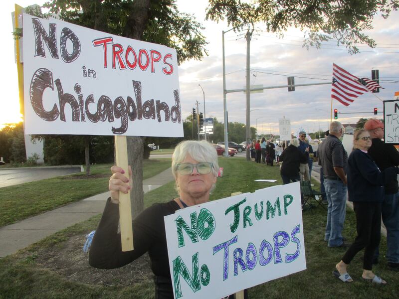 Kathleen Mirin of Romeoville displays signs at a protest in Joliet on Saturday as the Trump Administration makes plans to send the National Guard into Chicago. Sept. 6, 2025