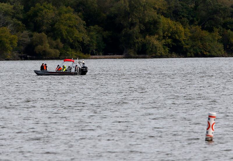 Divers from the Antioch Fire Protection District and a sonar team from the Illinois Department of Natural Resources continue searching Tuesday, Oct. 7, 2025, on Fox Lake near Antioch for a man thrown from a boat he was test driving Monday night.