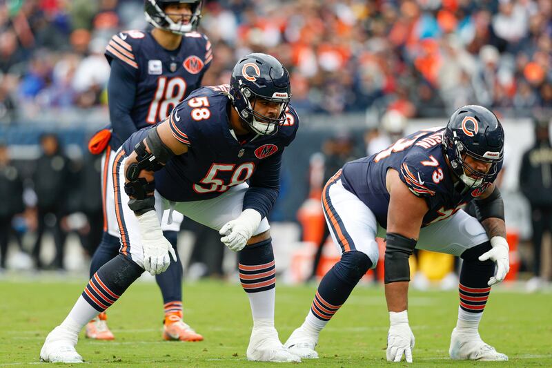 Chicago Bears offensive tackle Darnell Wright (58) and guard Jonah Jackson (73) line up during the first half of an NFL football game against the New Orleans Saints, Sunday, Oct. 19, 2025, in Chicago. (AP Photo/Kamil Krzaczynski)