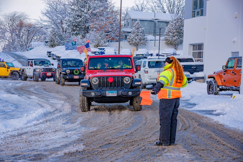 Jodie Auliff of the JOTR Road Crew directs traffic as Jeeps arrive at the Ray Chrysler Dodge Jeep Ram parking lot before the Jeeps on the Run Toys for Tots Run Dec. 7.