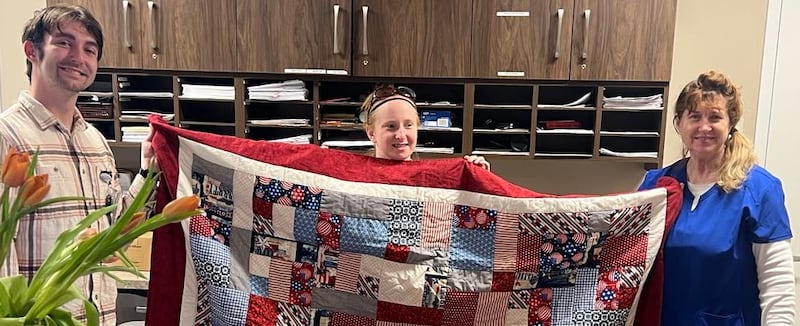 Retired U.S. Air Force Lt. Col. Julia Ritz (right) receives her Quilt of Valor honoring her military service.